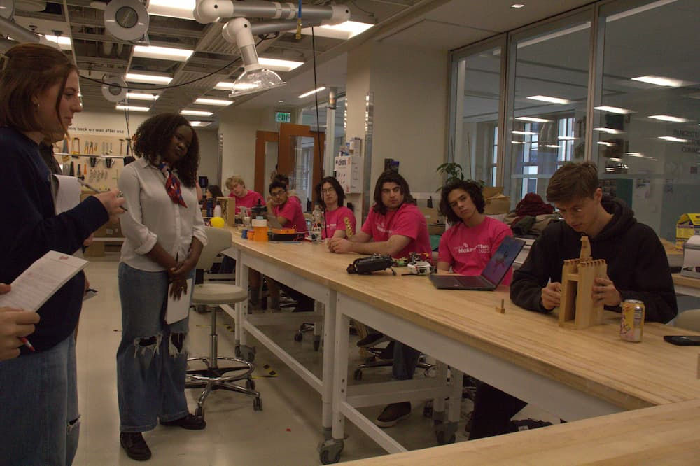 Make-a-thon 2025 Judges watching a groups presenation.