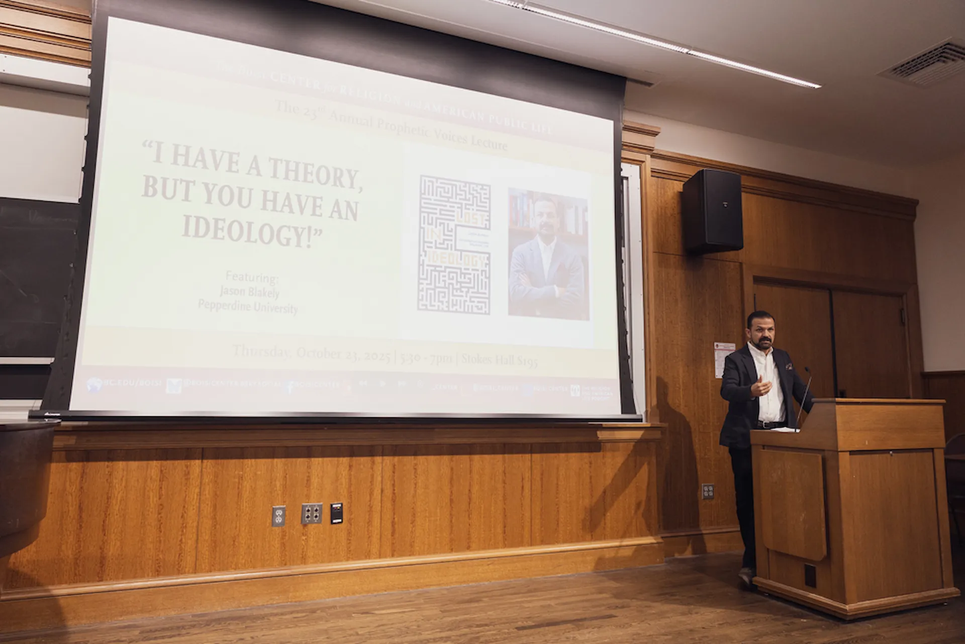 Blakely at podium with screen in background