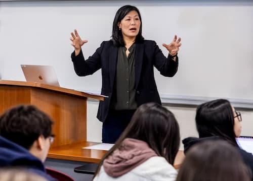 Arissa Oh speaks animatedly to a class of students