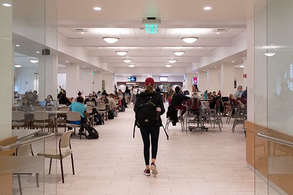 Three students in residence hall talking