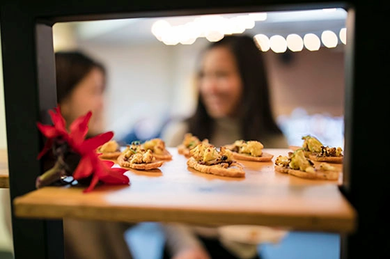 BC students looking in on canapes at a vegan pop-up event.