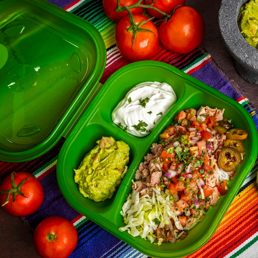 Green2Go takeout containers filled with Mexican food.