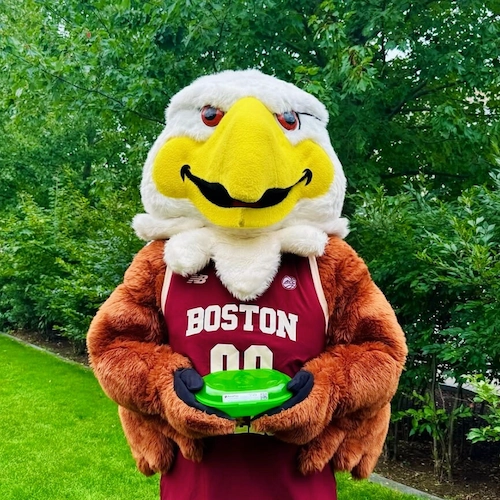BC Mascot, Baldwin, holding Green2Go takeout containers.
