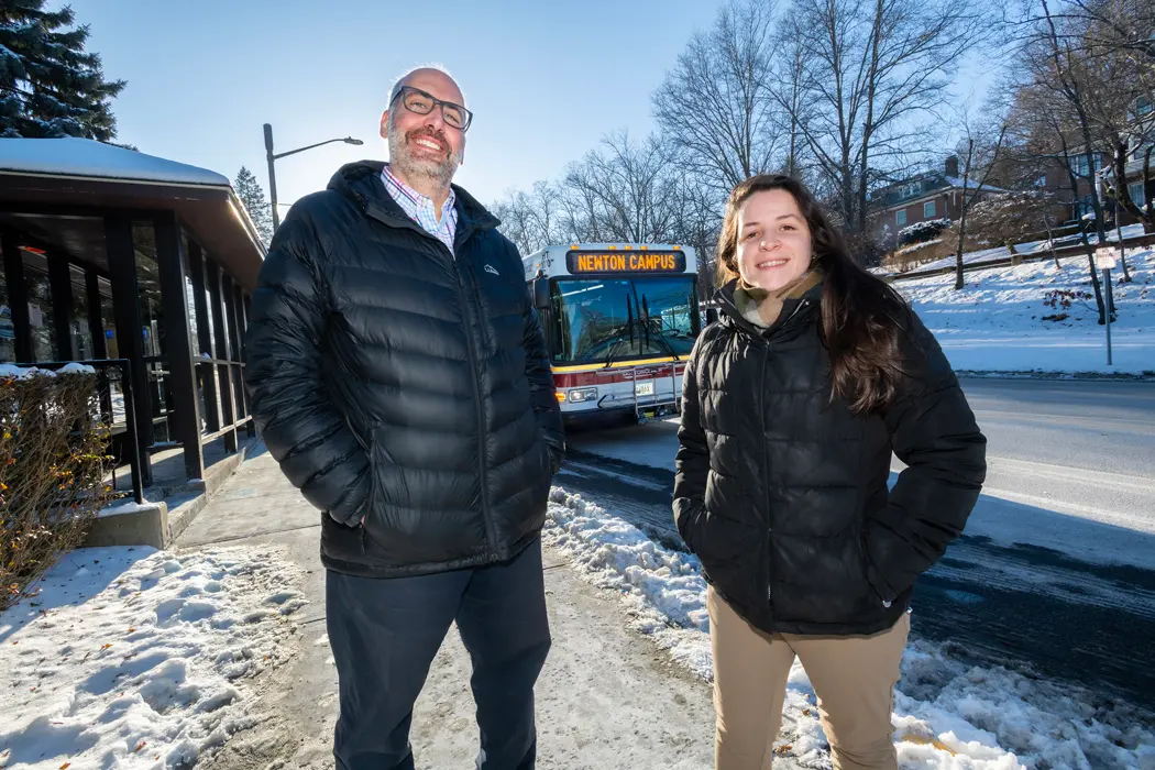 Two people standing on the sidewalk