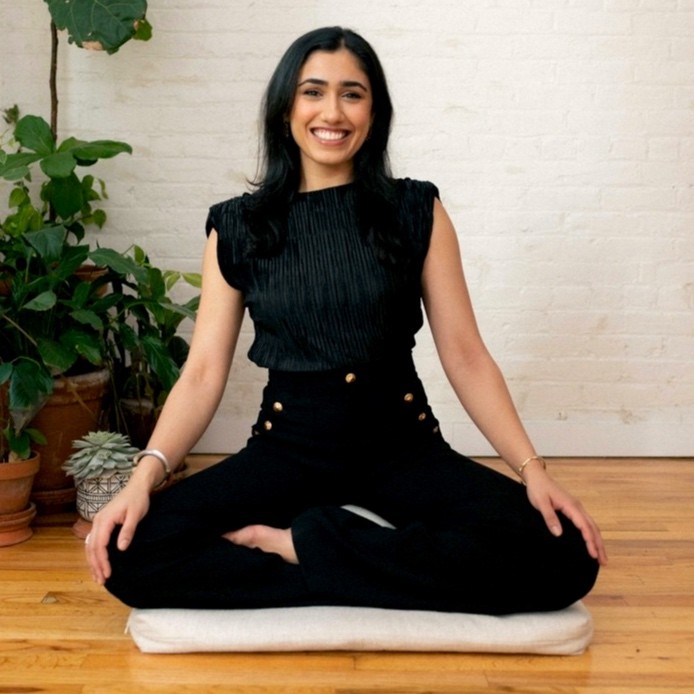 Karina Singhal sitting in a lotus postition. 