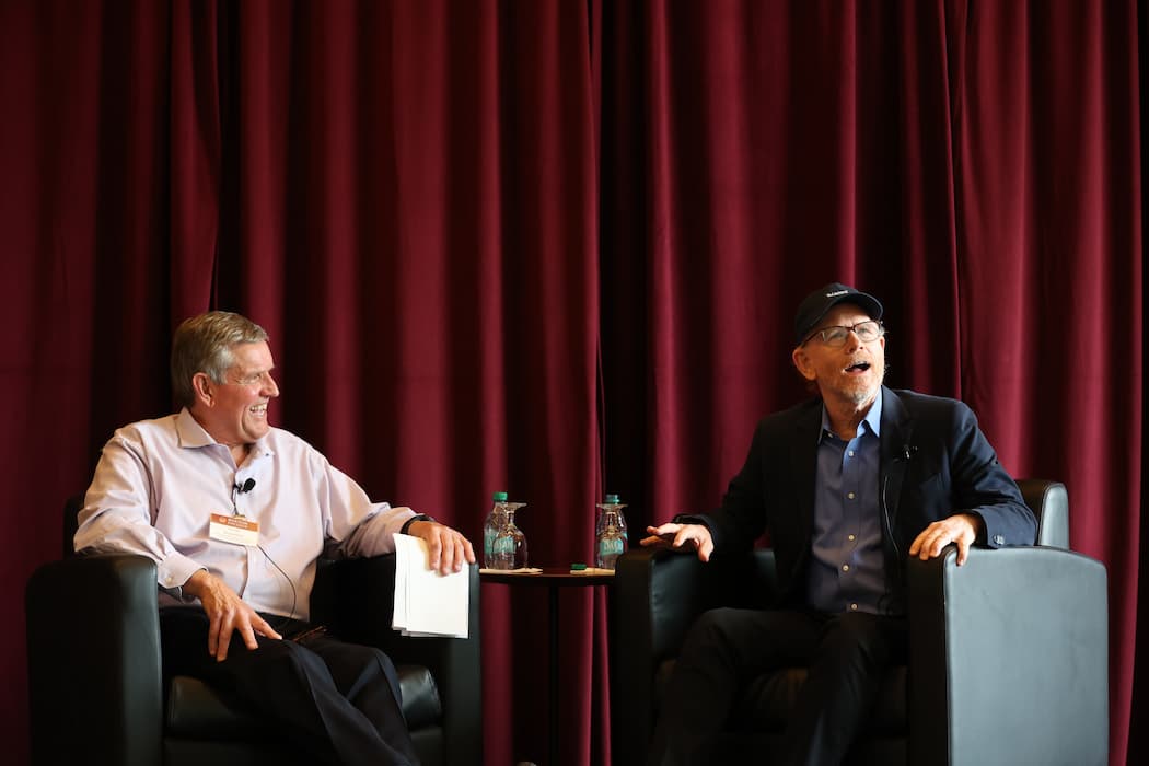  John and Linda Powers Family Dean Andy Boynton sits with Ron Howard on stage. 