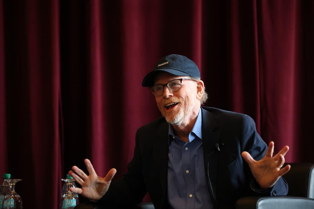 Ron Howard sits on stage at the finance conference. 