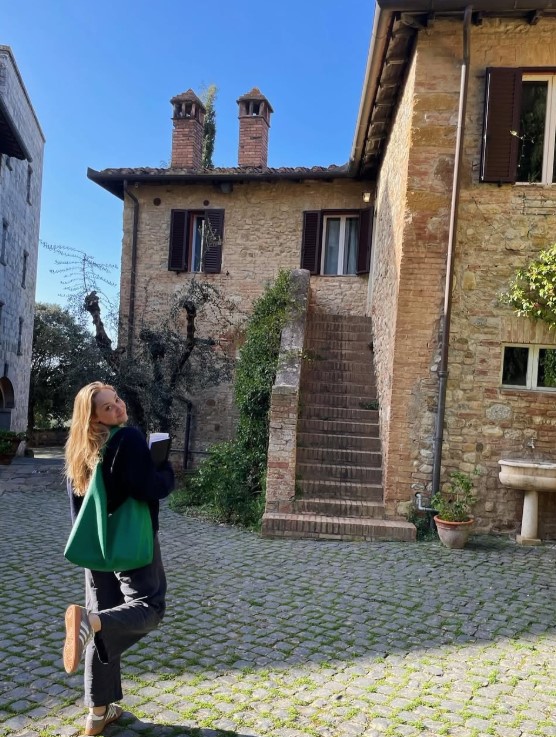 Nicole Robertson stands in front of a building in Italy. 