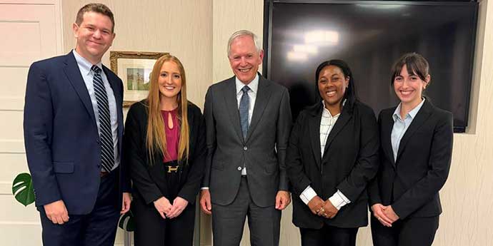 Hon. Hon. Paul Barbadoro ’80, center, praised the competitors, from left, Andrew Ordentlich ’26, Katie Queally ’26, Katherine Ovoian ’27, and Leia Washington ’27. 