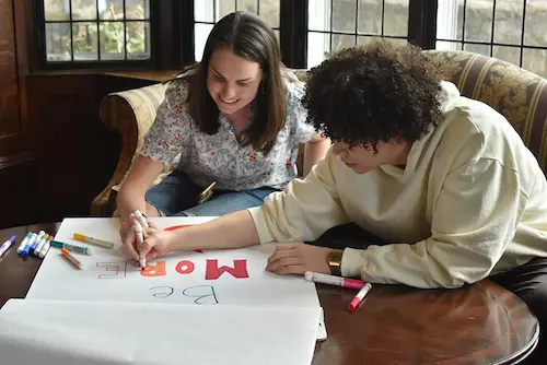 Two Boston College students working together on a reflection activity during the Halftime Retreat.