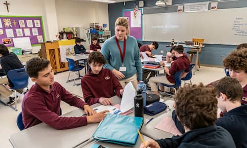 a teacher stands in front of students
