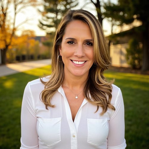 Yvonne Castañeda poses for a photo in a white shirt.