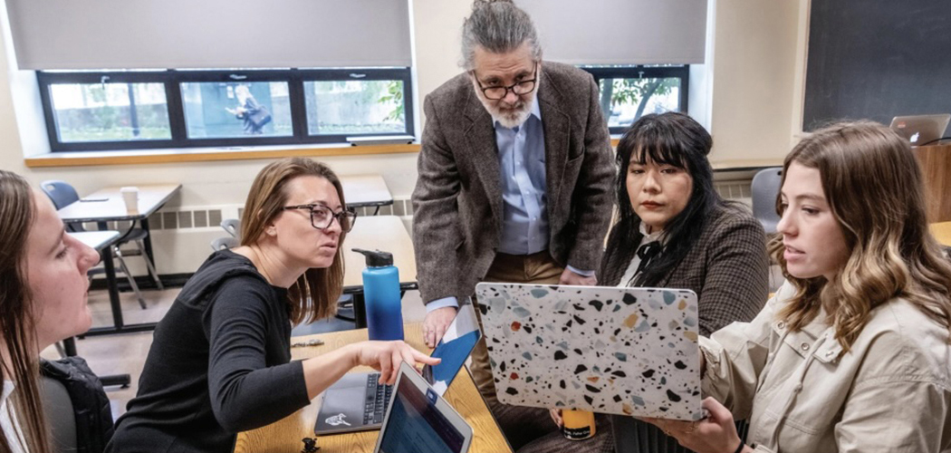 Professor Thomas Crea discusses a project with students.