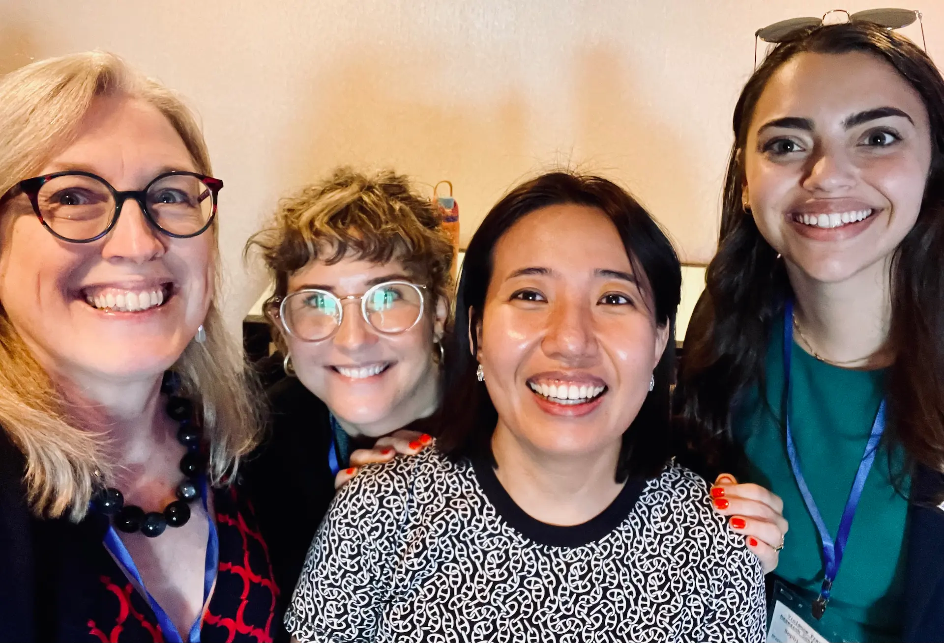Four research collaborators smiling for a selfie at the Violence Prevention Research Conference.
