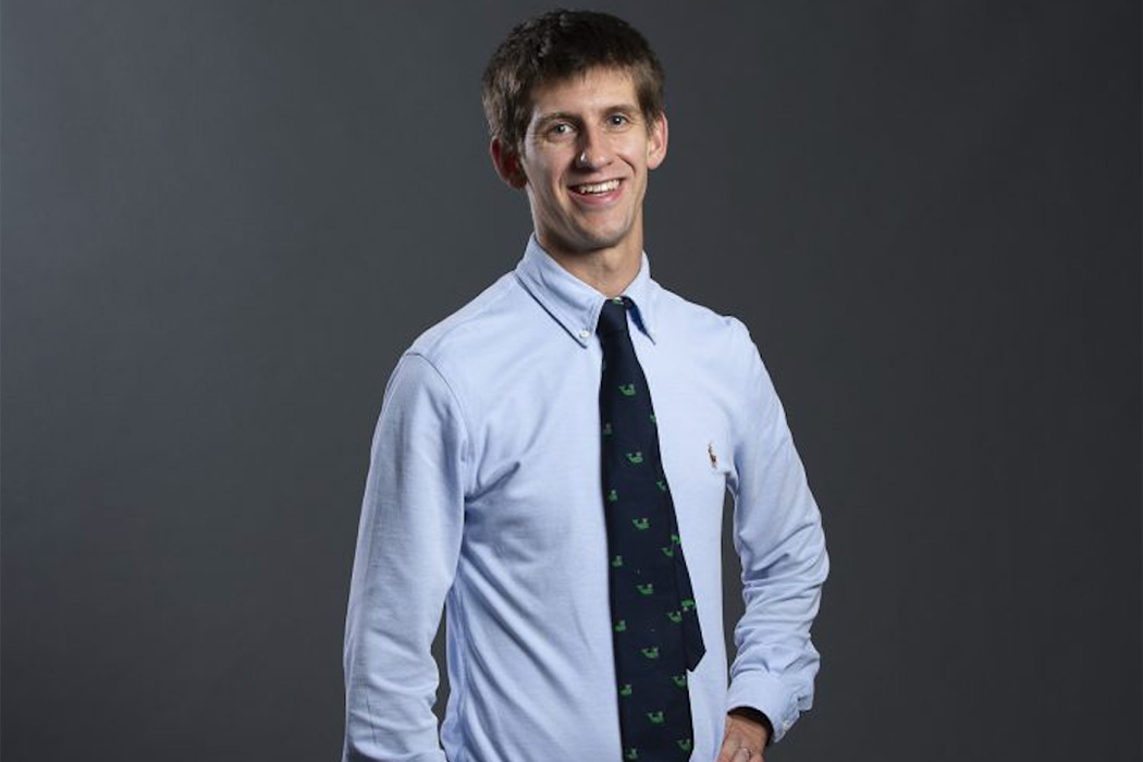 Tom Byrne, a newly appointed associate professor at the Boston College School of Social Work, in a sky blue shirt and navy blue tie.