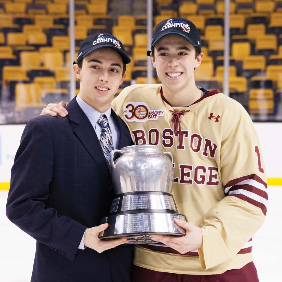 Brothers Johnny Gaudreau and Matthew Gaudreau arm in arm holding the Beanpot trophy