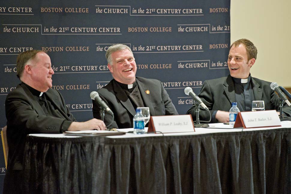 Leahy, Butler and Zipple smiling while seated at table with microphones