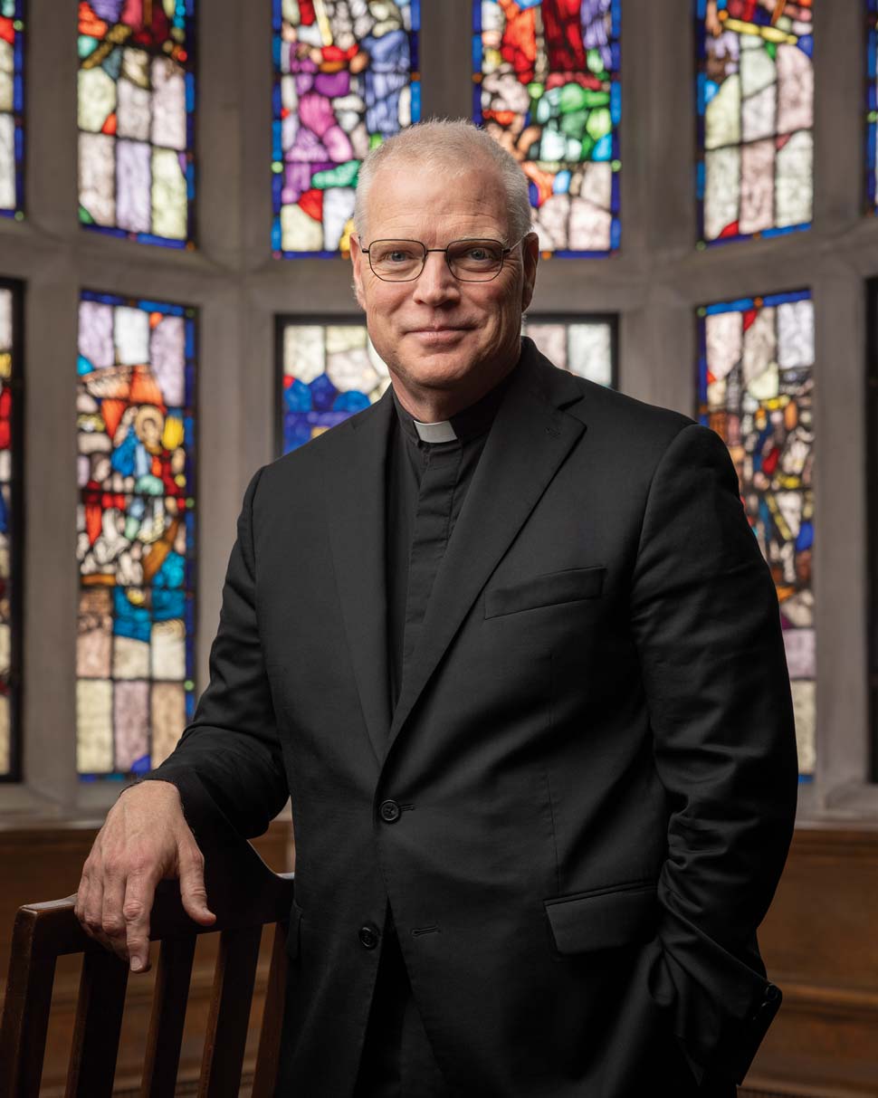 Photo of Jack Butler in the Thompson Room with the stained glass windows in the background
