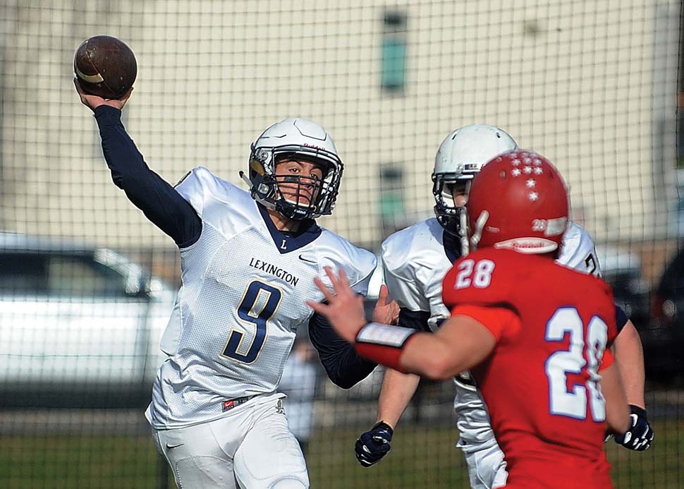 Frelick throwing the football with a lineman applying pressure