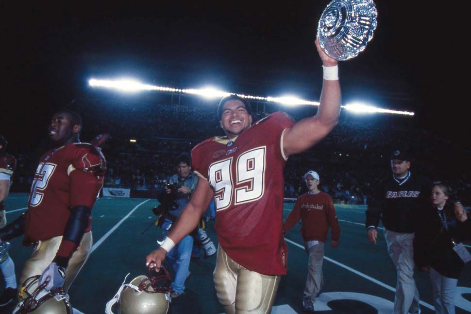 Gauthrie raising a trophy and looking up into the stands
