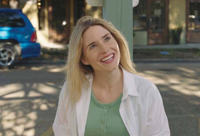 Portrait of Katie Corwin against a blue background