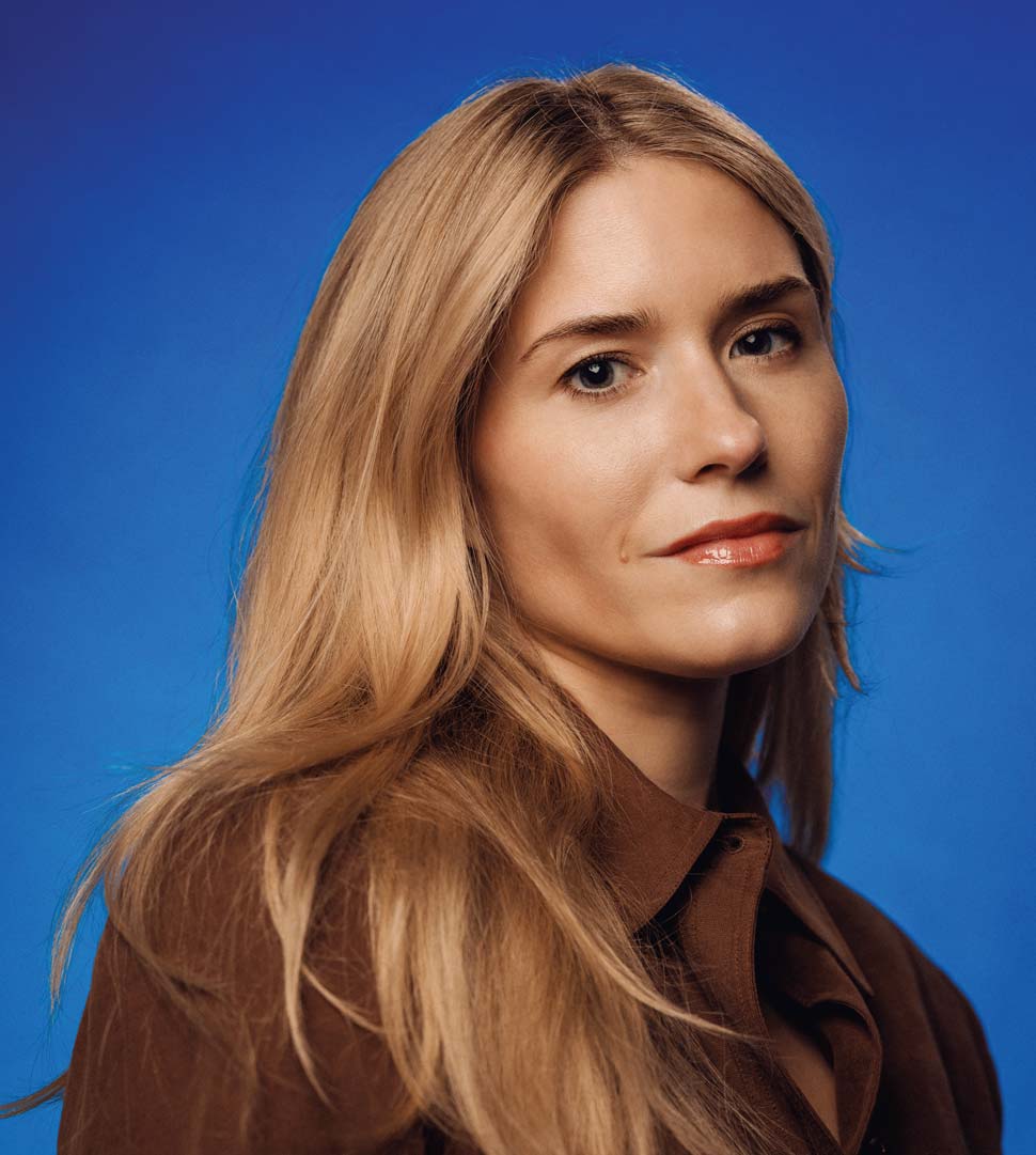 Portrait of Katie Corwin against a blue background