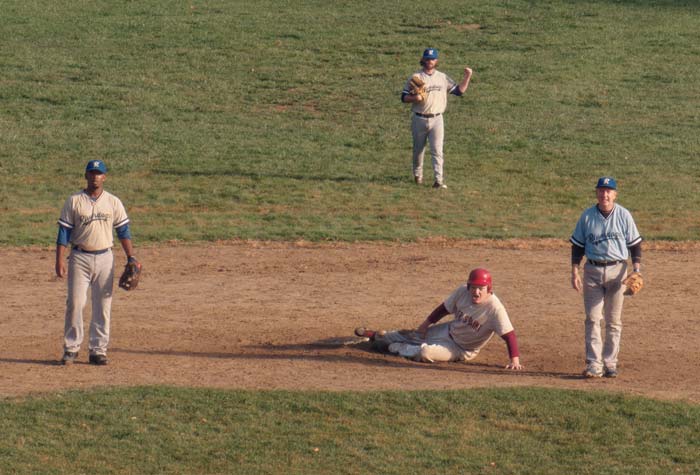 Film still of baseball players looking out from a dugout