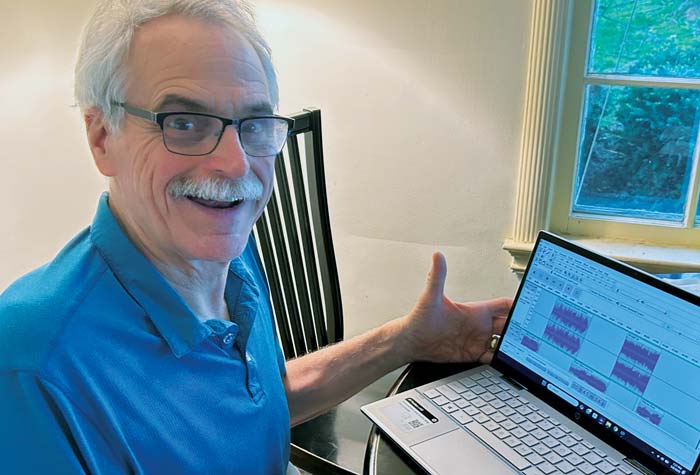 Hauenstein photographed producing show with laptop in his home