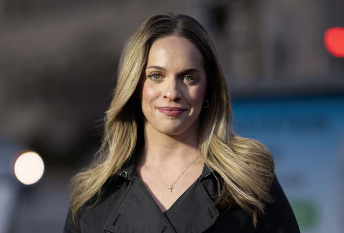 Rex photographed on sidewalk at dusk