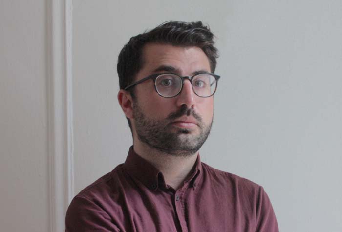 Lawson photographed with a gray wall in the background