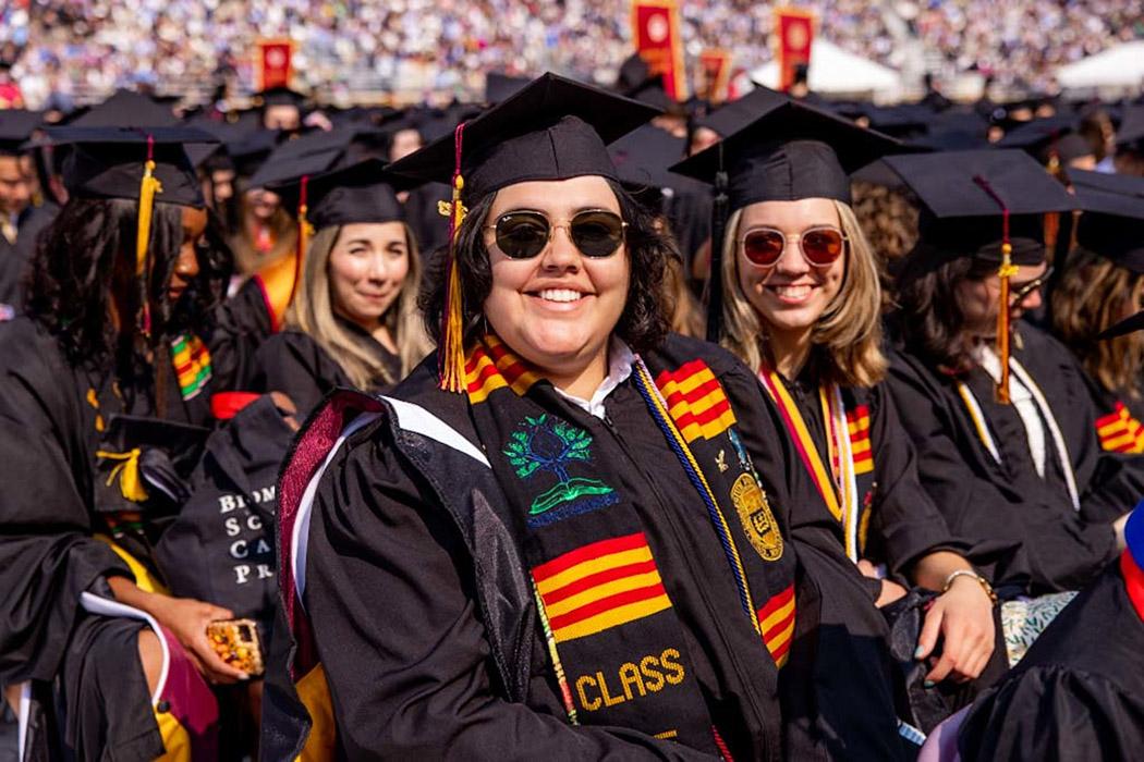 A group of students wearing caps and gowns at commencement