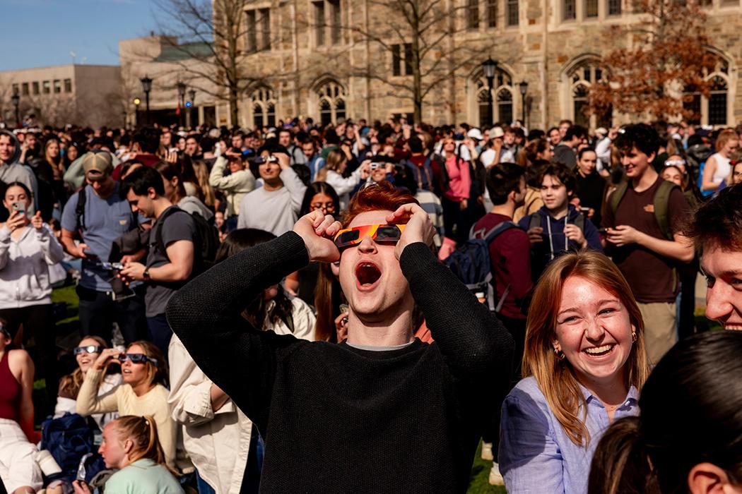 A group of students watching the solar eclipse