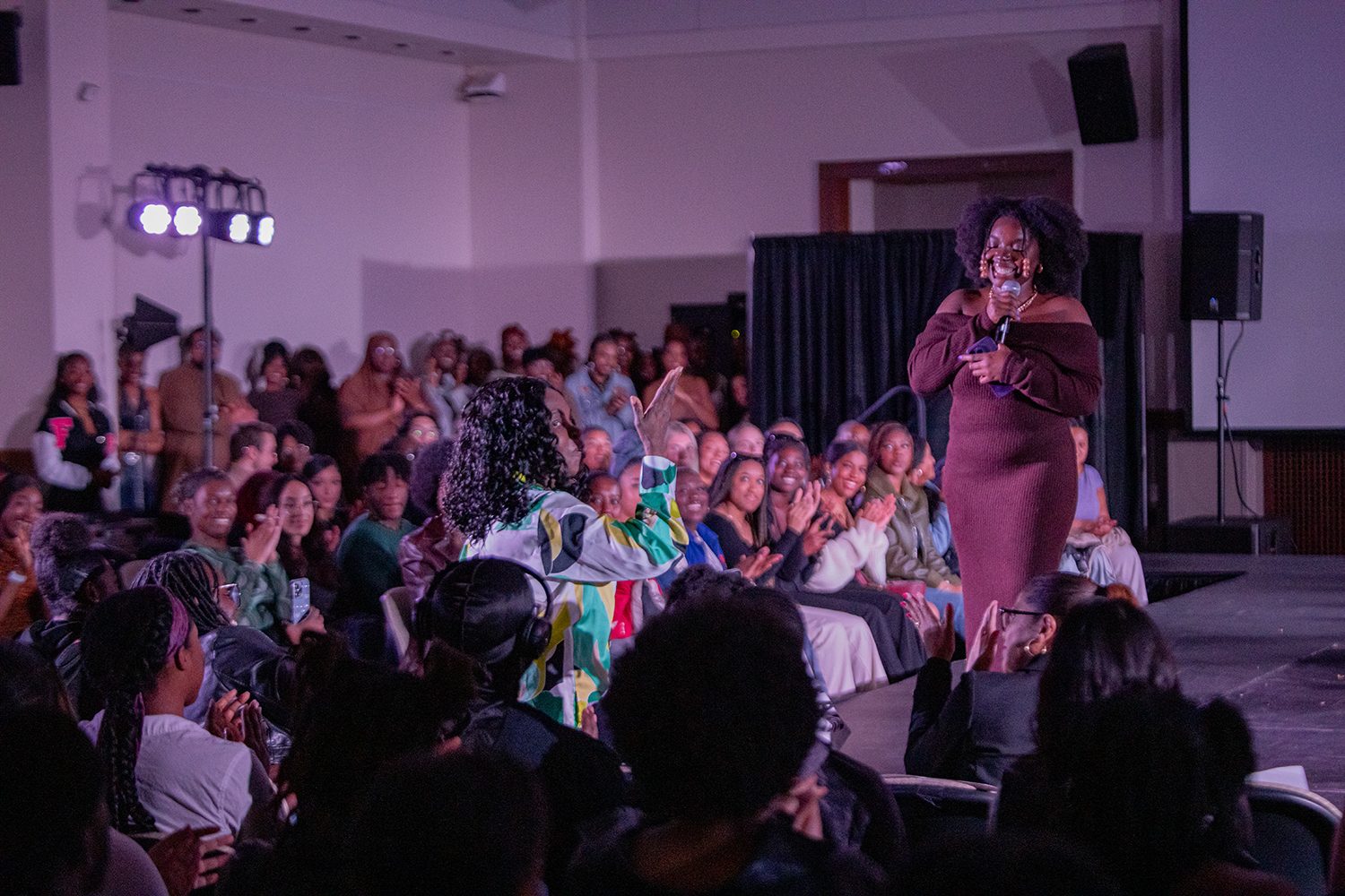 Ashley Dossous speaking from the runway