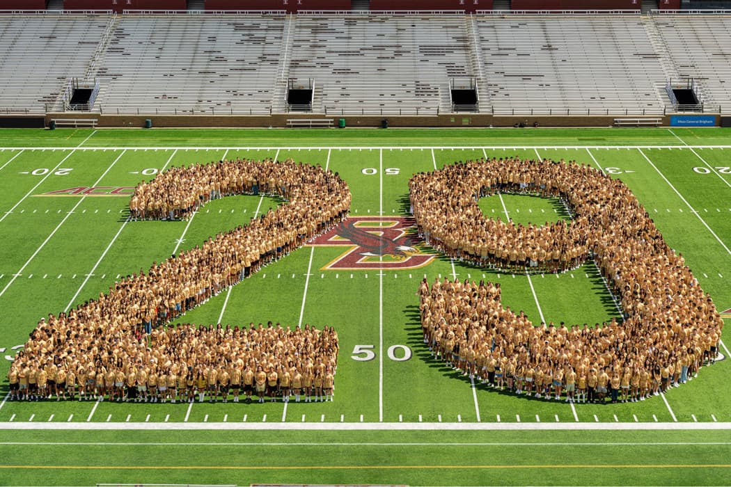 Students forming the number 29 on the field at Alumni Stadium