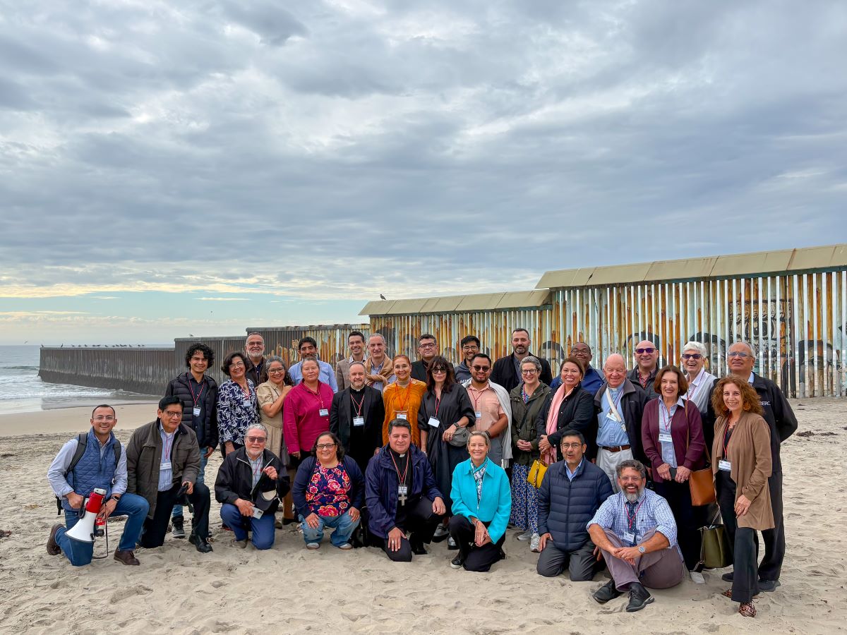 Colloquium attendees gathered at the border wall in Tijuana, Mexico. 