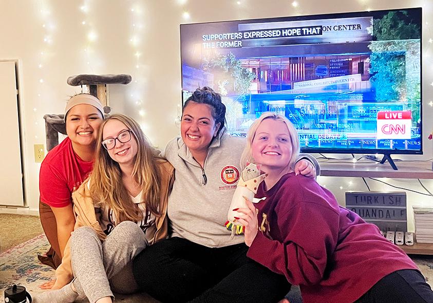 A group of students in front of a television