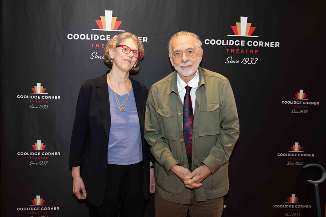Juliet Schor and Francis Ford Coppola in front of a theater banner