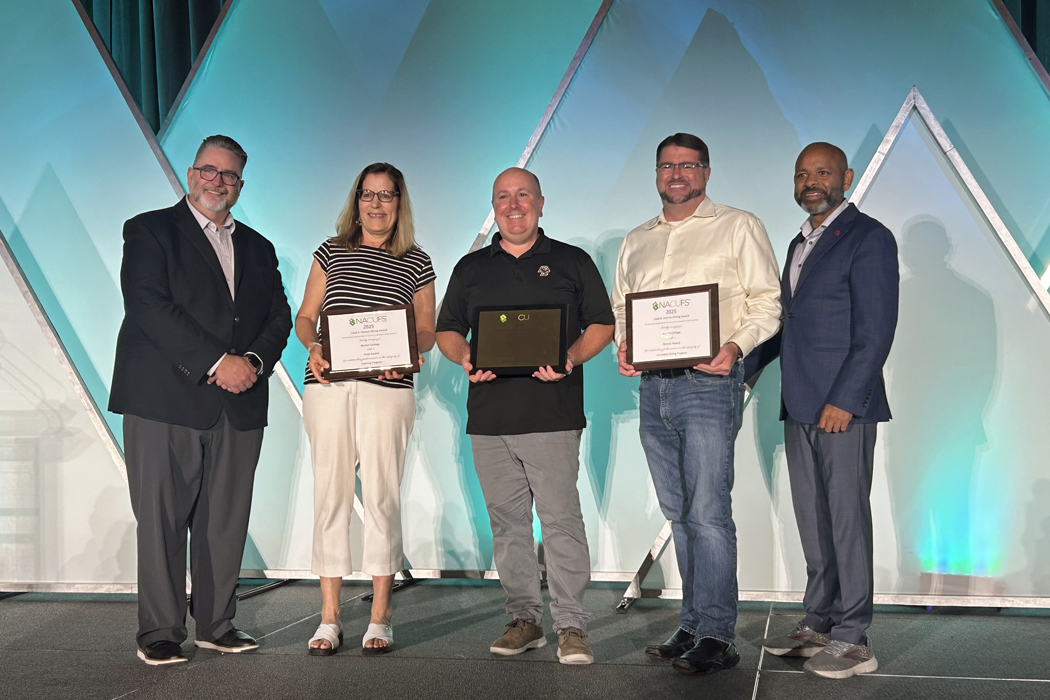 Five individuals at the awards ceremony.
