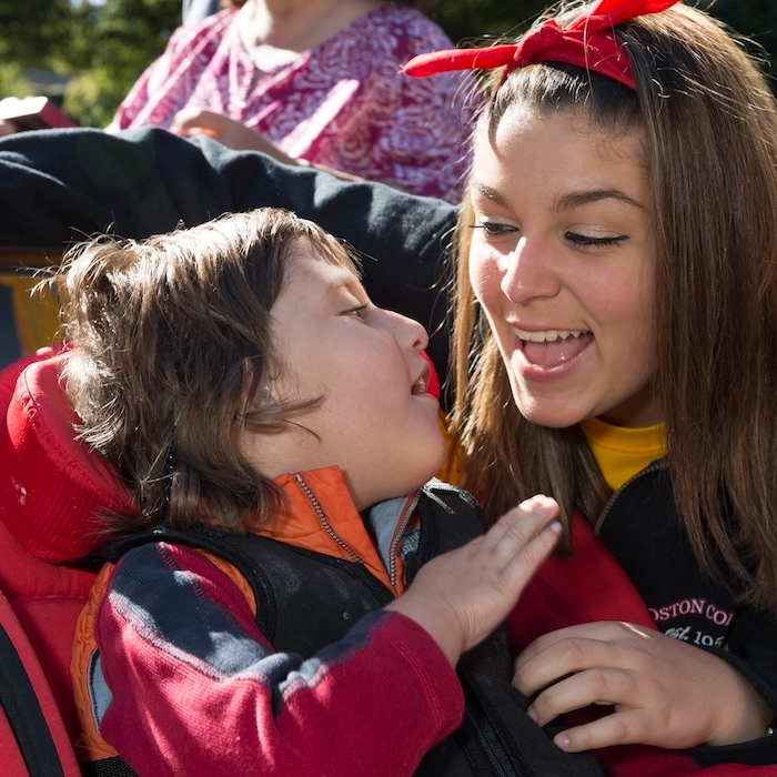 A student and child looking at each other