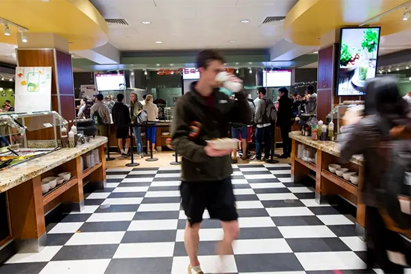 Student walking in dining hall